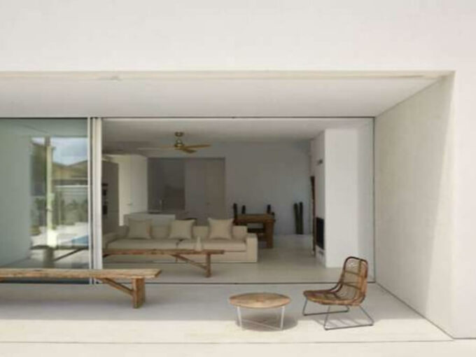 Covered terrace of Villa White in Estepona with open sliding glass doors to the living room