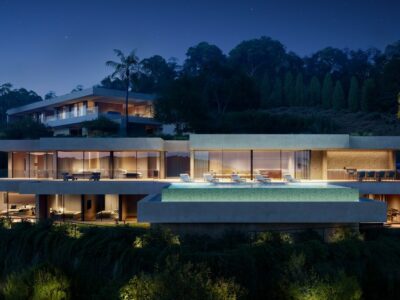 Villa Henrietta at night with lit terraces and pool in Montemayor, Benahavís