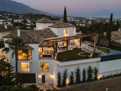 Villa Kumo at dusk with illuminated terraces in El Herrojo